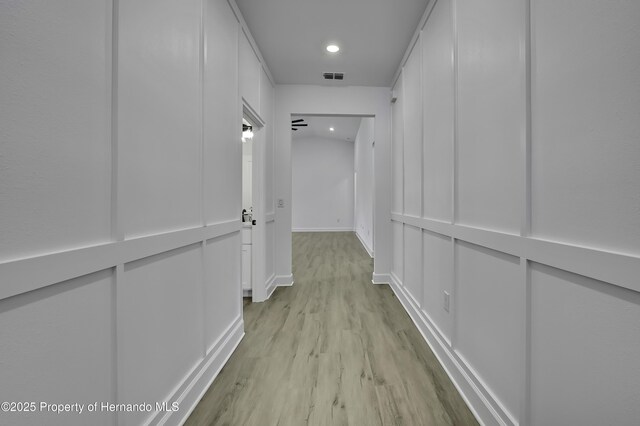 1080 Dunlap Ave, Spring Hill, FL 34609 - hallway featuring light wood finished floors, recessed lighting, and baseboards