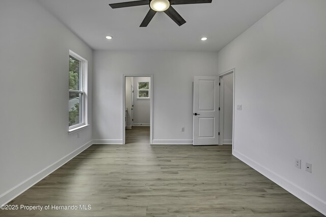 1080 Dunlap Ave, Spring Hill, FL 34609 - unfurnished bedroom featuring wood finished floors, recessed lighting, baseboards, and a ceiling fan
