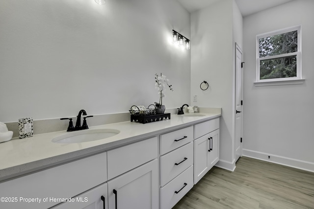 1080 Dunlap Ave, Spring Hill, FL 34609 - bathroom featuring double vanity, wood finished floors, and baseboards