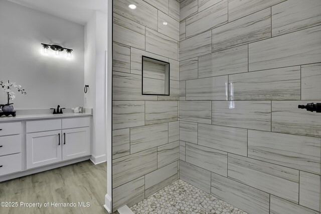 1080 Dunlap Ave, Spring Hill, FL 34609 - bathroom featuring a tile shower and vanity