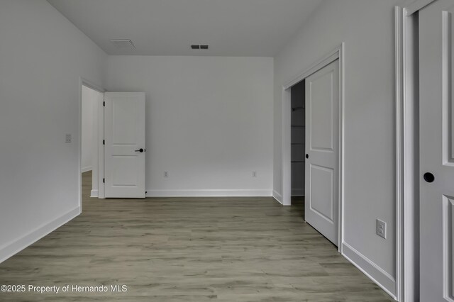 1080 Dunlap Ave, Spring Hill, FL 34609 - unfurnished bedroom featuring wood finished floors and baseboards