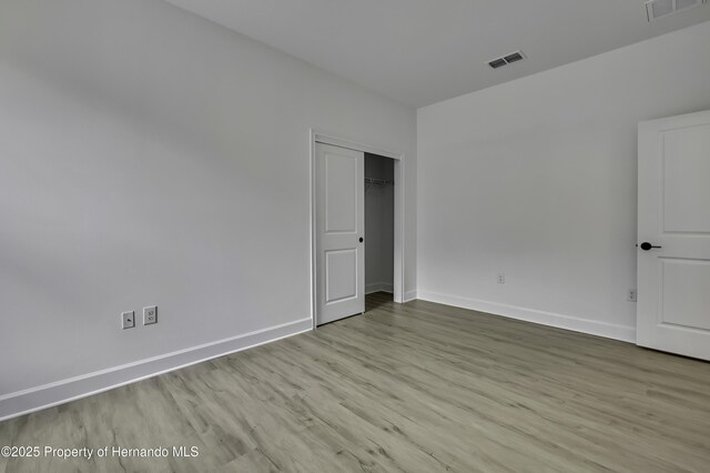 1080 Dunlap Ave, Spring Hill, FL 34609 - unfurnished bedroom with baseboards, wood finished floors, and a closet