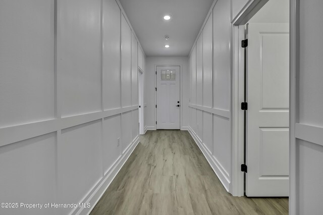 1080 Dunlap Ave, Spring Hill, FL 34609 - hall featuring light wood-type flooring, recessed lighting, and a decorative wall
