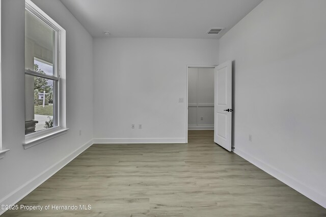 1080 Dunlap Ave, Spring Hill, FL 34609 - spare room with light wood finished floors and baseboards