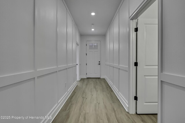 1080 Dunlap Ave, Spring Hill, FL 34609 - corridor with light wood finished floors, recessed lighting, and a decorative wall