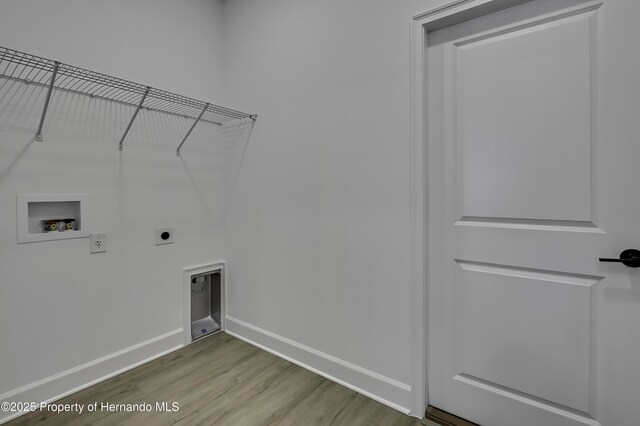 1080 Dunlap Ave, Spring Hill, FL 34609 - washroom with hookup for a washing machine, electric dryer hookup, baseboards, and wood finished floors