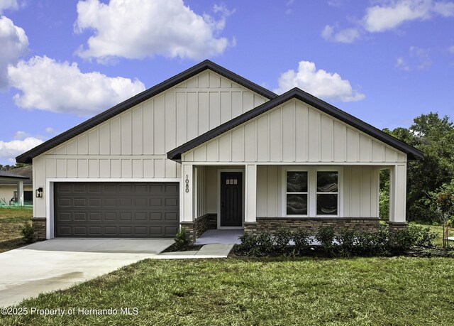 1080 Dunlap Ave, Spring Hill, FL 34609 - view of front of home with board and batten siding, a garage, a front lawn, and driveway