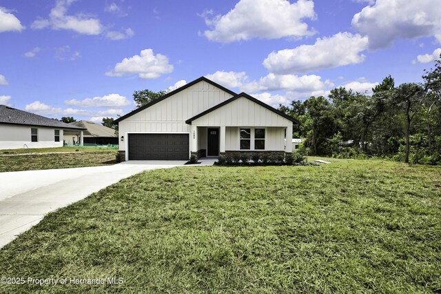 1080 Dunlap Ave, Spring Hill, FL 34609 - view of front of house featuring board and batten siding, driveway, a front yard, and a garage