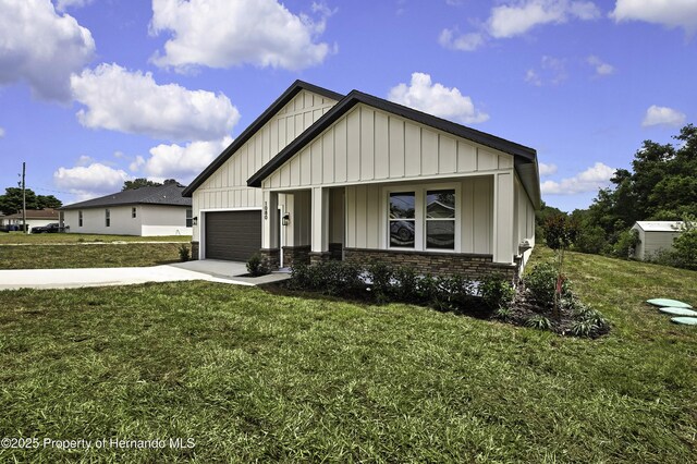 1080 Dunlap Ave, Spring Hill, FL 34609 - view of front of home featuring board and batten siding, concrete driveway, a front lawn, and an attached garage