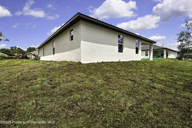 1080 Dunlap Ave, Spring Hill, FL 34609 - view of property exterior with stucco siding
