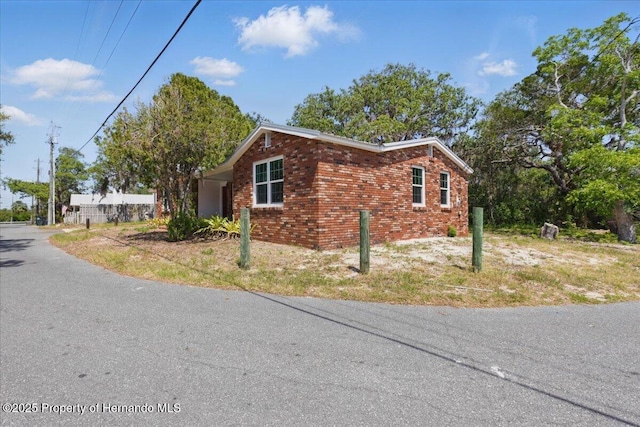 12301 Cedar St, Cedar Key, FL 32625 - view of home's exterior featuring brick siding