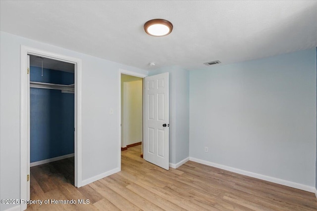 12301 Cedar St, Cedar Key, FL 32625 - unfurnished bedroom featuring light wood-style floors, baseboards, and a closet