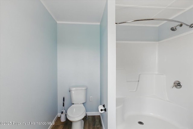 12301 Cedar St, Cedar Key, FL 32625 - bathroom with a shower, toilet, wood finished floors, ornamental molding, and baseboards