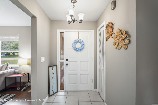 1038 Shenandoah Ln, Spring Hill, FL 34606 - entryway with a chandelier, baseboards, and light tile patterned flooring