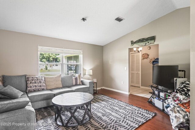 1038 Shenandoah Ln, Spring Hill, FL 34606 - living room featuring vaulted ceiling and wood finished floors