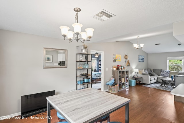 1038 Shenandoah Ln, Spring Hill, FL 34606 - dining area featuring a chandelier, dark wood-type flooring, and vaulted ceiling