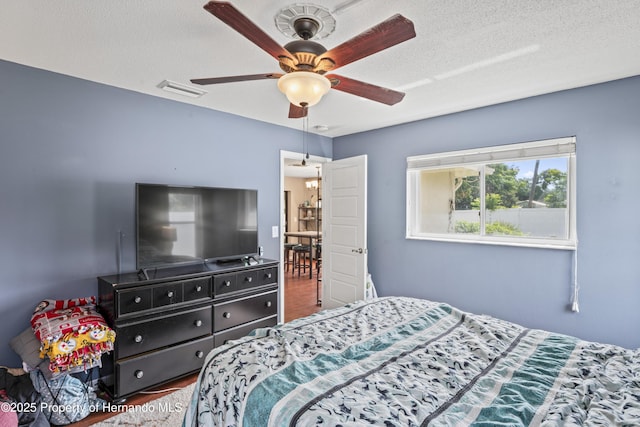 1038 Shenandoah Ln, Spring Hill, FL 34606 - bedroom featuring wood finished floors, a textured ceiling, and ceiling fan