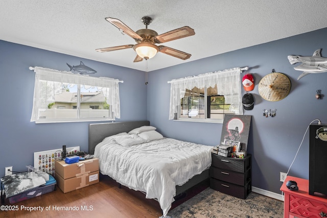 1038 Shenandoah Ln, Spring Hill, FL 34606 - bedroom featuring a textured ceiling, wood finished floors, and a ceiling fan