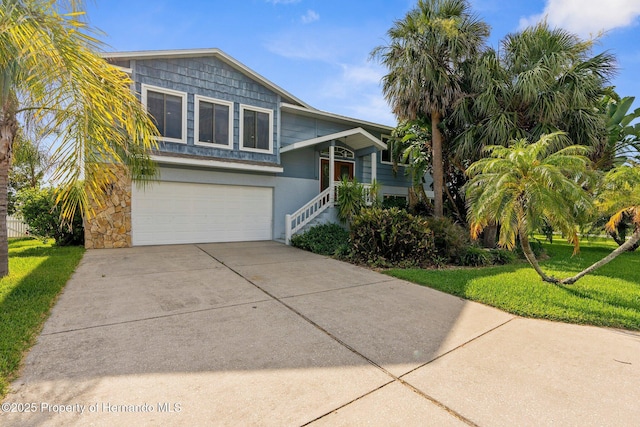 4523 Gulfstream Dr, Hernando Beach, FL 34607 - view of front of home with a garage, concrete driveway, and a front lawn