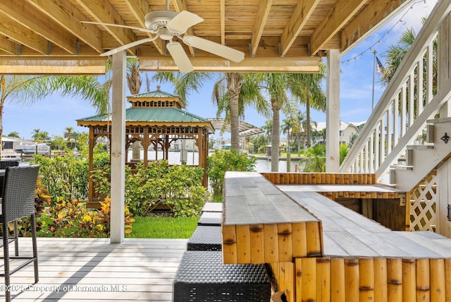 4523 Gulfstream Dr, Hernando Beach, FL 34607 - wooden deck with a ceiling fan, a water view, stairway, and a gazebo