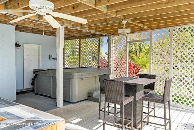 4523 Gulfstream Dr, Hernando Beach, FL 34607 - deck with a hot tub, a ceiling fan, and outdoor dining space