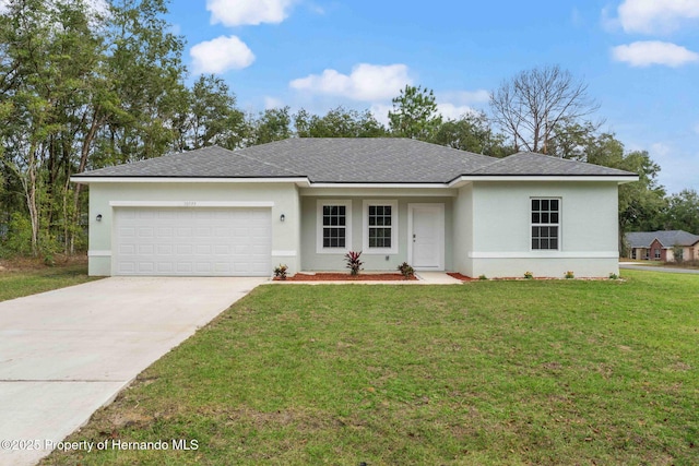 9908 N Essex Ter, Dunnellon, FL 34433 - single story home with an attached garage, stucco siding, a front lawn, and driveway