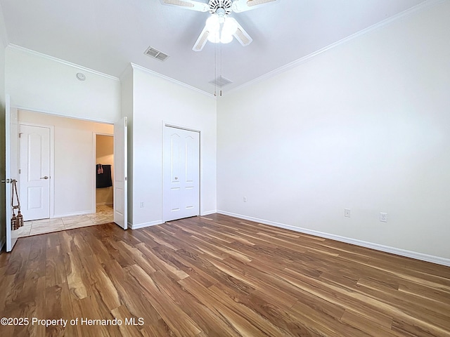 13417 Whitehaven Ct, Spring Hill, FL 34609 - unfurnished bedroom with ornamental molding, wood finished floors, baseboards, a closet, and ceiling fan