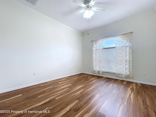 13417 Whitehaven Ct, Spring Hill, FL 34609 - empty room featuring wood finished floors, a ceiling fan, baseboards, and ornamental molding