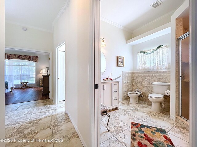 13417 Whitehaven Ct, Spring Hill, FL 34609 - bathroom with ornamental molding, a bidet, a stall shower, marble finish flooring, and toilet