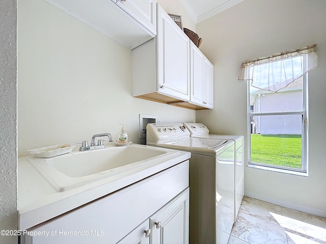 13417 Whitehaven Ct, Spring Hill, FL 34609 - washroom with independent washer and dryer, cabinet space, light marble finish floors, healthy amount of natural light, and crown molding