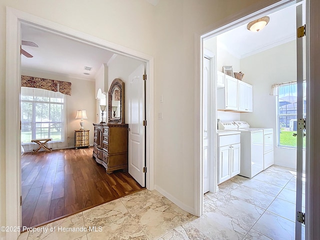 13417 Whitehaven Ct, Spring Hill, FL 34609 - hall with crown molding, light marble finish floors, baseboards, plenty of natural light, and independent washer and dryer