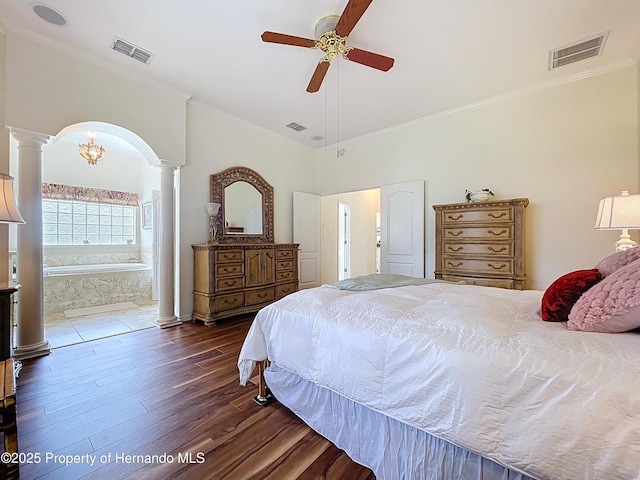 13417 Whitehaven Ct, Spring Hill, FL 34609 - bedroom featuring decorative columns, dark wood finished floors, crown molding, arched walkways, and ensuite bath