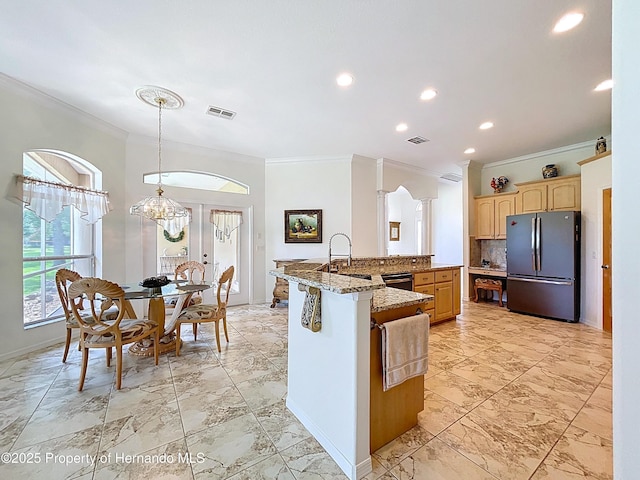 13417 Whitehaven Ct, Spring Hill, FL 34609 - kitchen with freestanding refrigerator, crown molding, a sink, light brown cabinetry, and light marble finish flooring