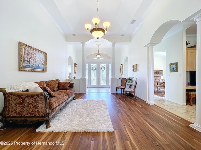 13417 Whitehaven Ct, Spring Hill, FL 34609 - entryway featuring decorative columns, crown molding, arched walkways, wood finished floors, and french doors