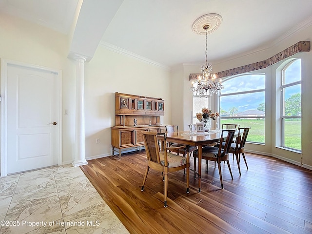 13417 Whitehaven Ct, Spring Hill, FL 34609 - dining space with ornate columns, ornamental molding, baseboards, and a chandelier