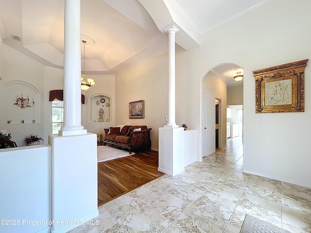 13417 Whitehaven Ct, Spring Hill, FL 34609 - hallway with ornate columns, crown molding, arched walkways, baseboards, and light marble finish flooring