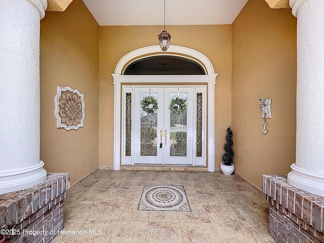 13417 Whitehaven Ct, Spring Hill, FL 34609 - entrance to property with french doors and stucco siding
