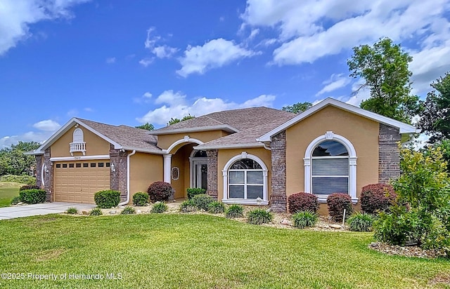 13417 Whitehaven Ct, Spring Hill, FL 34609 - view of front of home with an attached garage, a front yard, stucco siding, and concrete driveway