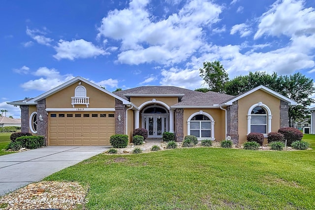 13417 Whitehaven Ct, Spring Hill, FL 34609 - view of front of property featuring french doors, stucco siding, a front yard, and an attached garage