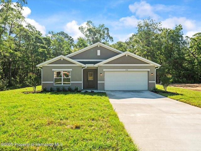 14448 Chimney Swift Rd, Weeki Wachee, FL 34614 - craftsman house with concrete driveway, a front lawn, a garage, and stucco siding