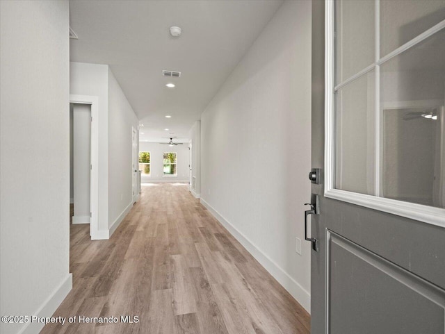 14448 Chimney Swift Rd, Weeki Wachee, FL 34614 - hall with light wood-style floors, baseboards, and recessed lighting
