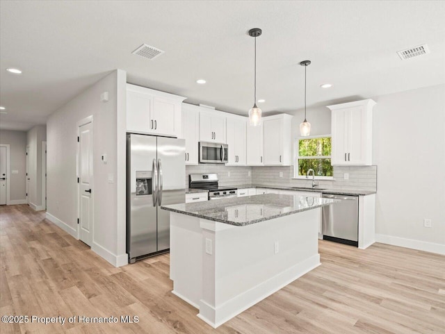 14448 Chimney Swift Rd, Weeki Wachee, FL 34614 - kitchen featuring stainless steel appliances, a sink, light wood-type flooring, backsplash, and recessed lighting