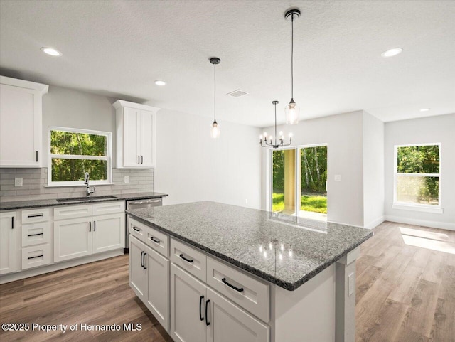 14448 Chimney Swift Rd, Weeki Wachee, FL 34614 - kitchen featuring a sink, healthy amount of natural light, tasteful backsplash, a chandelier, and recessed lighting
