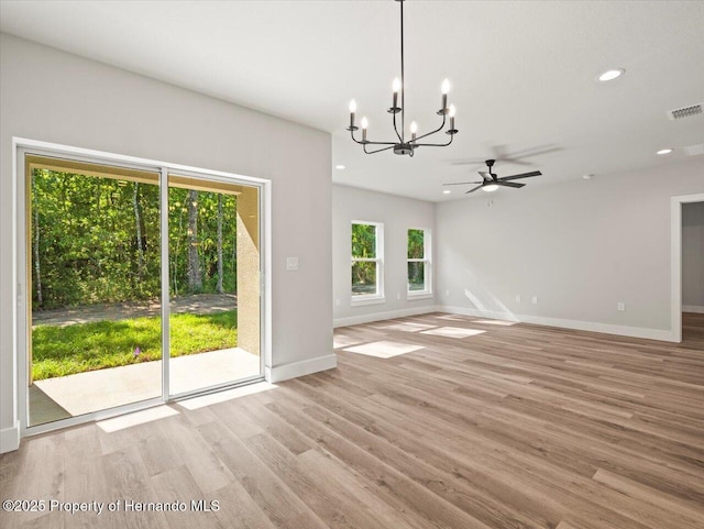 14448 Chimney Swift Rd, Weeki Wachee, FL 34614 - unfurnished living room with a chandelier, baseboards, light wood finished floors, recessed lighting, and ceiling fan
