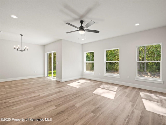14448 Chimney Swift Rd, Weeki Wachee, FL 34614 - unfurnished room featuring a chandelier, baseboards, light wood-type flooring, and recessed lighting
