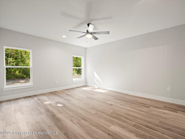 14448 Chimney Swift Rd, Weeki Wachee, FL 34614 - spare room featuring healthy amount of natural light, baseboards, light wood-type flooring, and recessed lighting