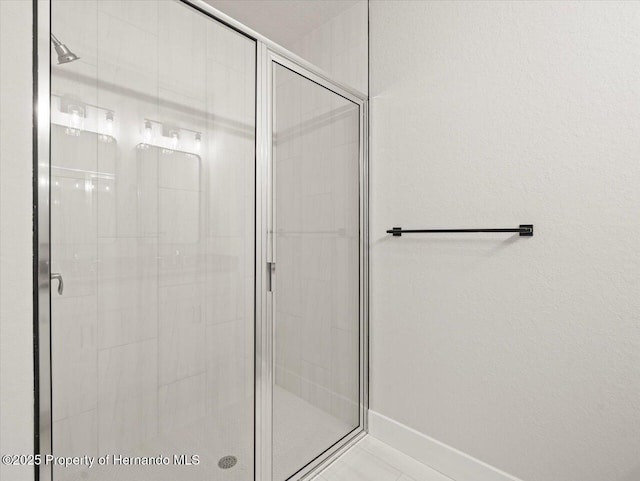 14448 Chimney Swift Rd, Weeki Wachee, FL 34614 - bathroom with a shower stall and baseboards