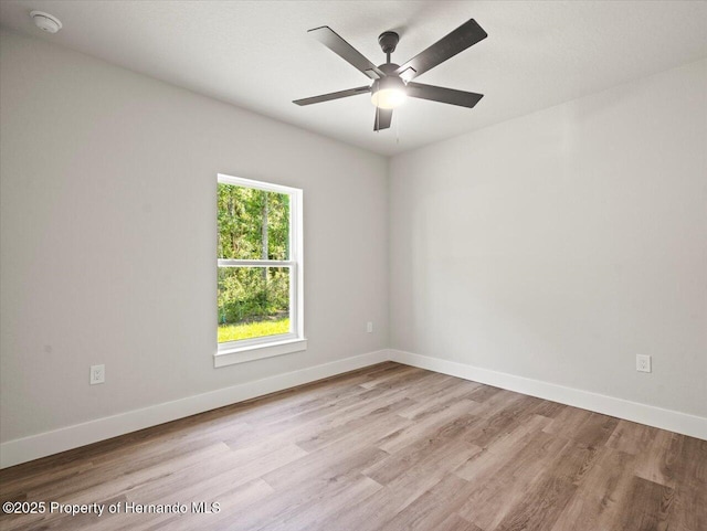 14448 Chimney Swift Rd, Weeki Wachee, FL 34614 - spare room with a smoke detector, light wood-type flooring, and baseboards