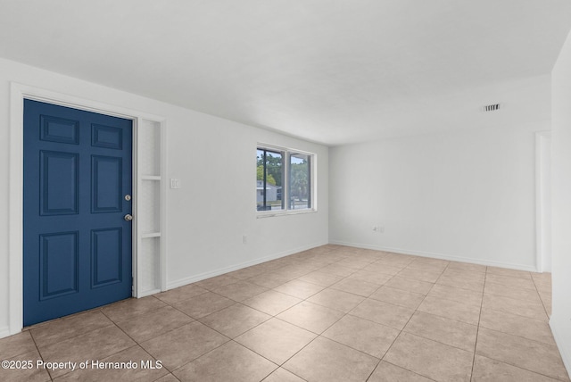 6633 Jackson St, New Port Richey, FL 34653 - unfurnished room with light tile patterned floors and baseboards