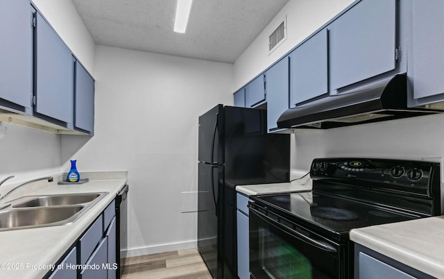 6519 W Newberry Rd Unit 107, Gainesville, FL 32605 - kitchen with black electric range oven, under cabinet range hood, blue cabinetry, a sink, and light countertops